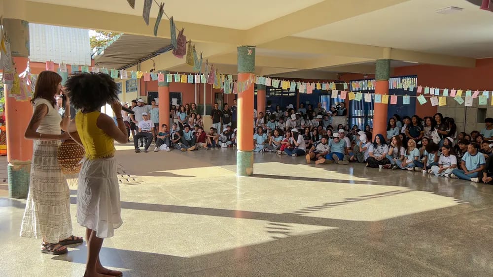 Duas apresentadoras conduzem a abertura no pátio, diante do público sentado